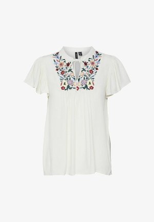 Balta blūze ar īsām, plūstošām piedurknēm, dekorēta ar krāsainiem ziedu izšuvumiem ap kaklu un ar saites detaļu. Viegls audums.