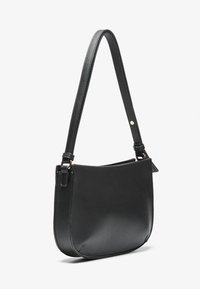 Black leather shoulder bag with a smooth texture, curved design, adjustable strap, and a single accent button on the strap.