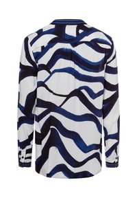 Camicia a maniche lunghe con sfondo bianco e motivi a onde blu, con polsini abbottonati e colletto a contrasto. Realizzata in un tessuto leggero.
