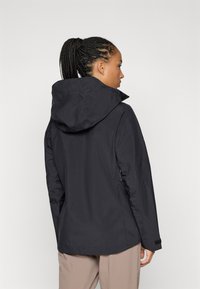 Black waterproof jacket with a hood, featuring a smooth texture, a relaxed fit, and side pockets, seen from the back.