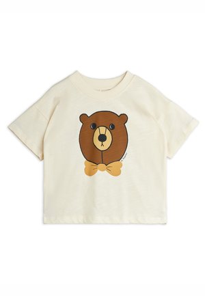 T-shirt pour tout-petit à manches courtes couleur crème avec un visage d'ours brun portant un nœud papillon jaune moutarde imprimé à l'avant.