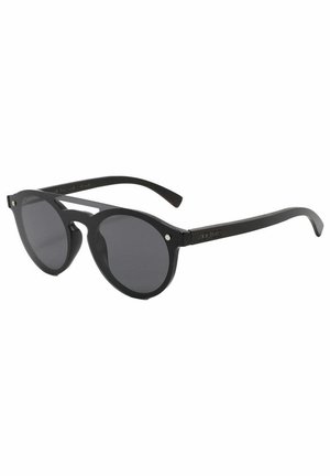 Occhiali da sole neri rotondi con lenti scure, dotati di una montatura in plastica spessa e dettagli in metallo sulle cerniere. Design minimalista con texture liscia.