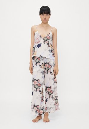 Floral patterned sleeveless top with a V-neck and loose-fit palazzo pants, both in light fabric featuring pink and navy designs.