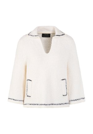 White textured long-sleeve pullover with black trim on collar, pocket openings, cuffs, and hem, featuring a deep V-neck collar.