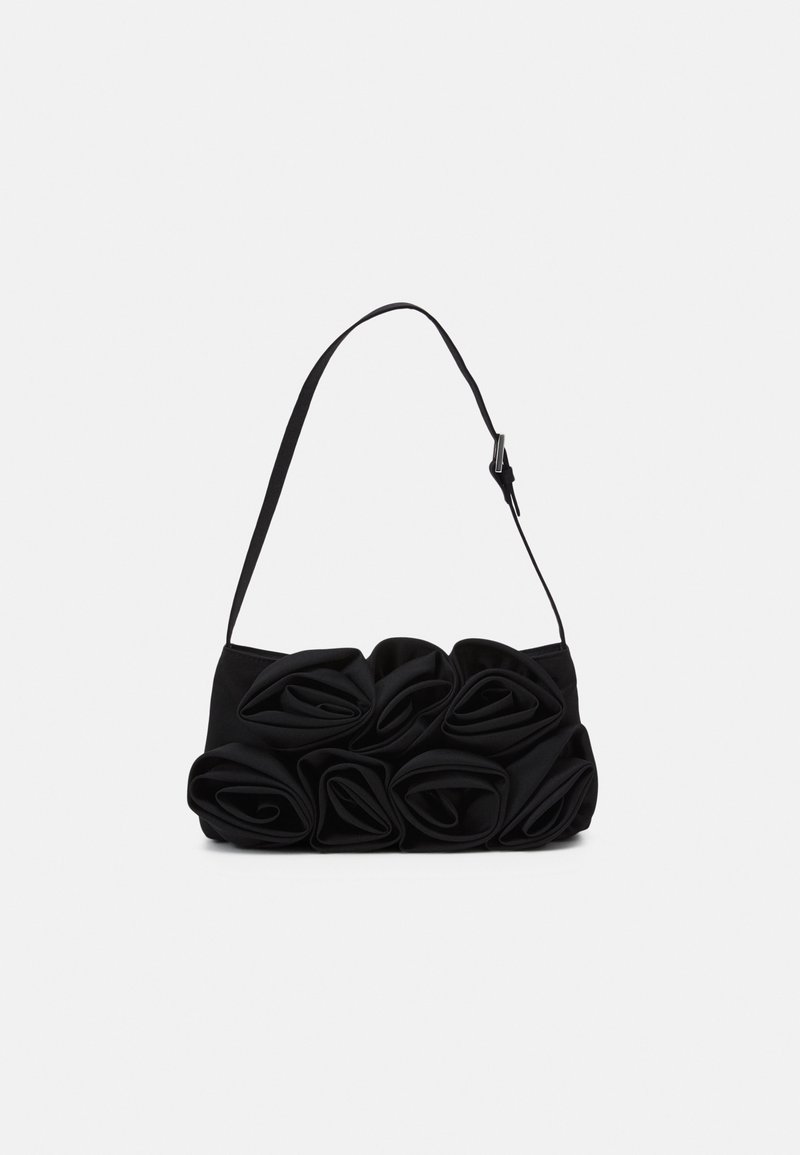 Borsa nera con tracolla regolabile, decorata con grandi rose di tessuto piegate sulla parte anteriore, su uno sfondo bianco.
