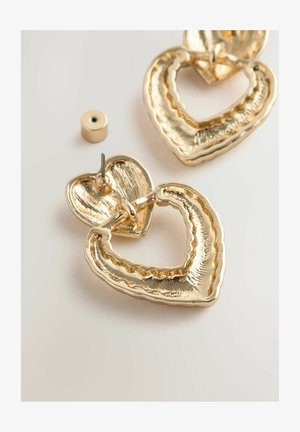 Gold heart-shaped earrings with textured detailing and a layered design. Posts for secure wear included. Finishes are shiny and metallic.