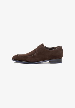 Brown suede shoe with a rounded toe, featuring a contrasting thin white seam along the upper edge and a low, solid heel.