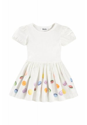 Vestito bianco per bambino con maniche a sbuffo e gonna decorata con stampe colorate di macarons in tonalità pastello.