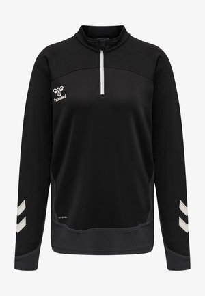 Pull noir à manches longues avec col montant et zip quart. Présente le logo Hummel blanc et des chevrons sur les manches, tissu texturé.