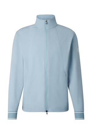 Hellblaue Langarmjacke mit hohem Kragen, Frontreißverschluss, Seitentaschen, strukturierten Bündchen und Logo am linken Ärmel.