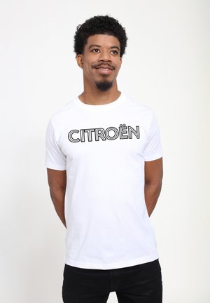 T-shirt en coton blanc à manches courtes avec le mot "CITROËN" imprimé en lettres noires en gras sur la poitrine.