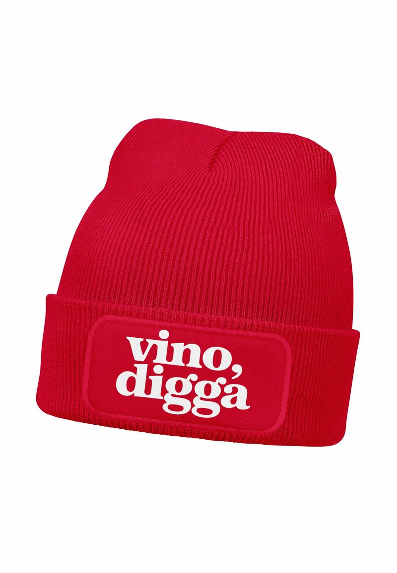 Red knitted beanie with a rolled cuff, featuring a white rectangular patch with the text “vino, digga” in bold typography.