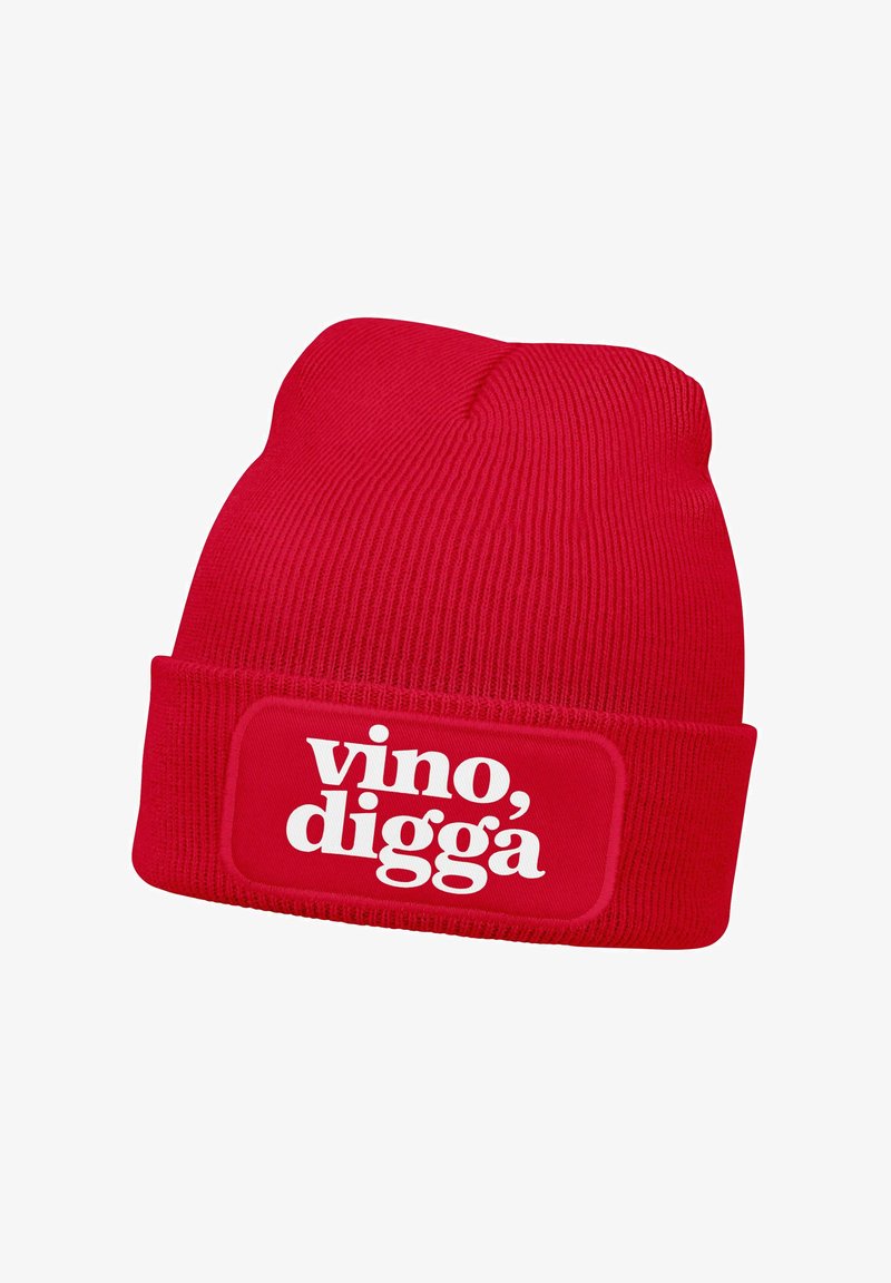 Red knitted beanie with a rolled cuff, featuring a white rectangular patch with the text “vino, digga” in bold typography.