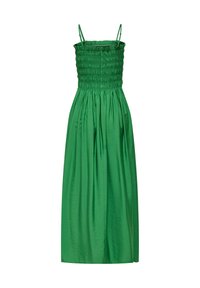 Robe verte sans manches avec fines bretelles, corsage froncé, boutons sur le devant et une longue jupe fluide.