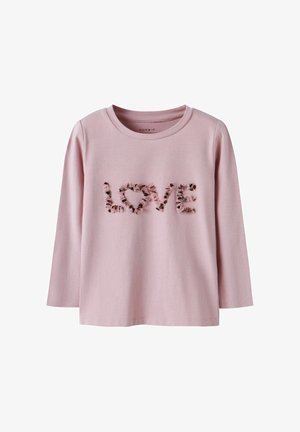 T-shirt a maniche lunghe rosa realizzato in cotone morbido. Presenta il testo in rilievo "LOVE" con una texture arricciata, scollo rotondo e orlo dritto.