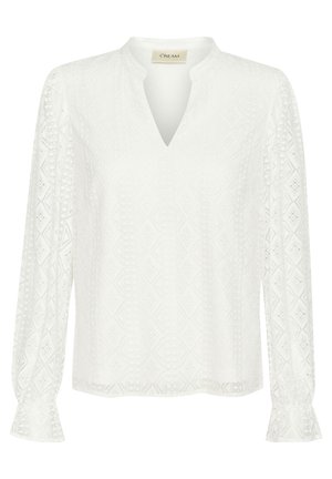Blouse blanche à manches longues avec un col en V, texture en losanges complexe et poignets à volants. Fabriquée en tissu léger.