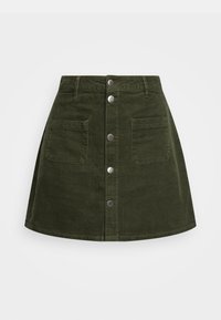 Grön kordflorskjol med en utsvängd design, som har knäppning fram med knappar och två framfickor. Strukturerad tyg med vertikala ränder.