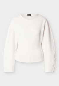 Λευκό κοντό τοπ με μακριά, δομημένα μανίκια. Λείο ύφασμα, στρογγυλή λαιμόκοψη και λεπτομέρεια με ραφή στη μέση. Μινιμαλιστικός σχεδιασμός, χωρίς ορατούς κλειδώματα.