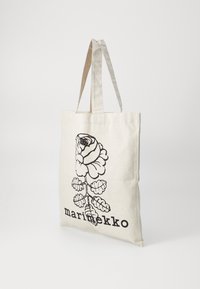 Tote bag made of natural canvas, featuring a large black rose design and the text "marimekko" at the bottom. Two fabric handles.