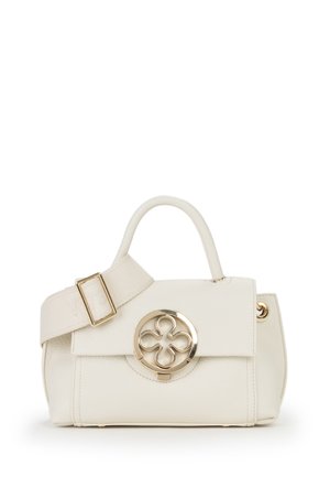 Sac à main couleur crème avec une poignée courte, une large bandoulière ajustable et un fermoir rond en or présentant un motif floral à quatre pétales.