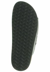 Schwarze Gummisohle mit einem Zickzack-Muster, strukturiert für Grip und mit einem leicht beigen Rand. Langlebiges Material verbessert Stabilität und Unterstützung.