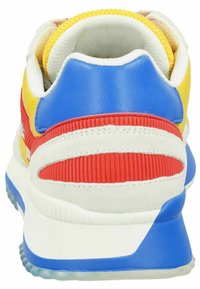 Multicolored sneaker featuring blue, red, yellow, and white materials. Textured heel and smooth leather accents along a cushioned sole.