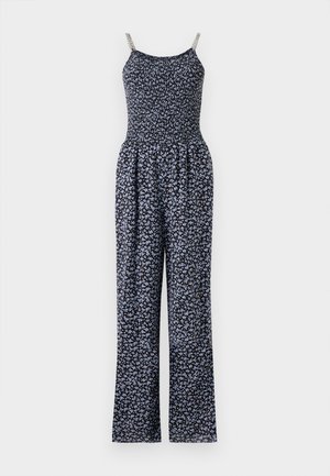 Blumiger Jumpsuit mit einem gerüschten Oberteil, schwarzem Stoff, der mit kleinen blauen Blumen verziert ist, und silbernen Ketten-Trägern. Weite Bein-Silhouette.