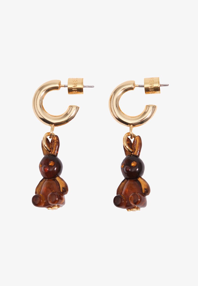 Kuldsete rõngakujuliste kõrvarõngaste küljes rippuvad väikesed kollakamad jänesekujulised ripatsid, mis on valge taustaga ja suunaga ettepoole.