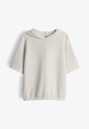 Wit kortademig capuchonshirt van wafelstof met een losse pasvorm en een klein merketiket aan de binnenzijde van de halslijn.