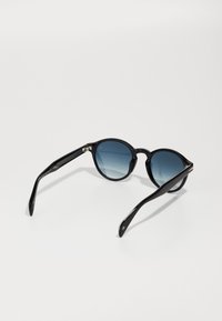 Black round sunglasses with gradient blue lenses. Sleek plastic frames, curved arms, and silver accents on the temple. Light reflective surface.