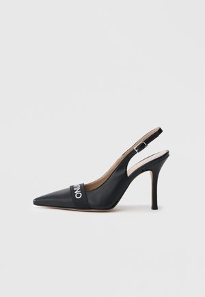 Black leather slingback pump with a pointed toe, 10 cm heel, and a horizontal strap featuring a white logo across the vamp.