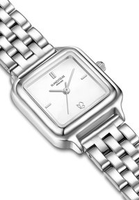 Montre en acier inoxydable argenté avec un cadran carré, un fond blanc et trois aiguilles. Le bracelet présente un design tissé. Marquée "GLANZSTÜCKE MÜNCHEN."