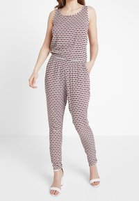 Flerfärgad jumpsuit med ett mönstrat linne, elastisk midja och avsmalnande ben. Tillverkad av lättviktsmaterial med sidofickor.