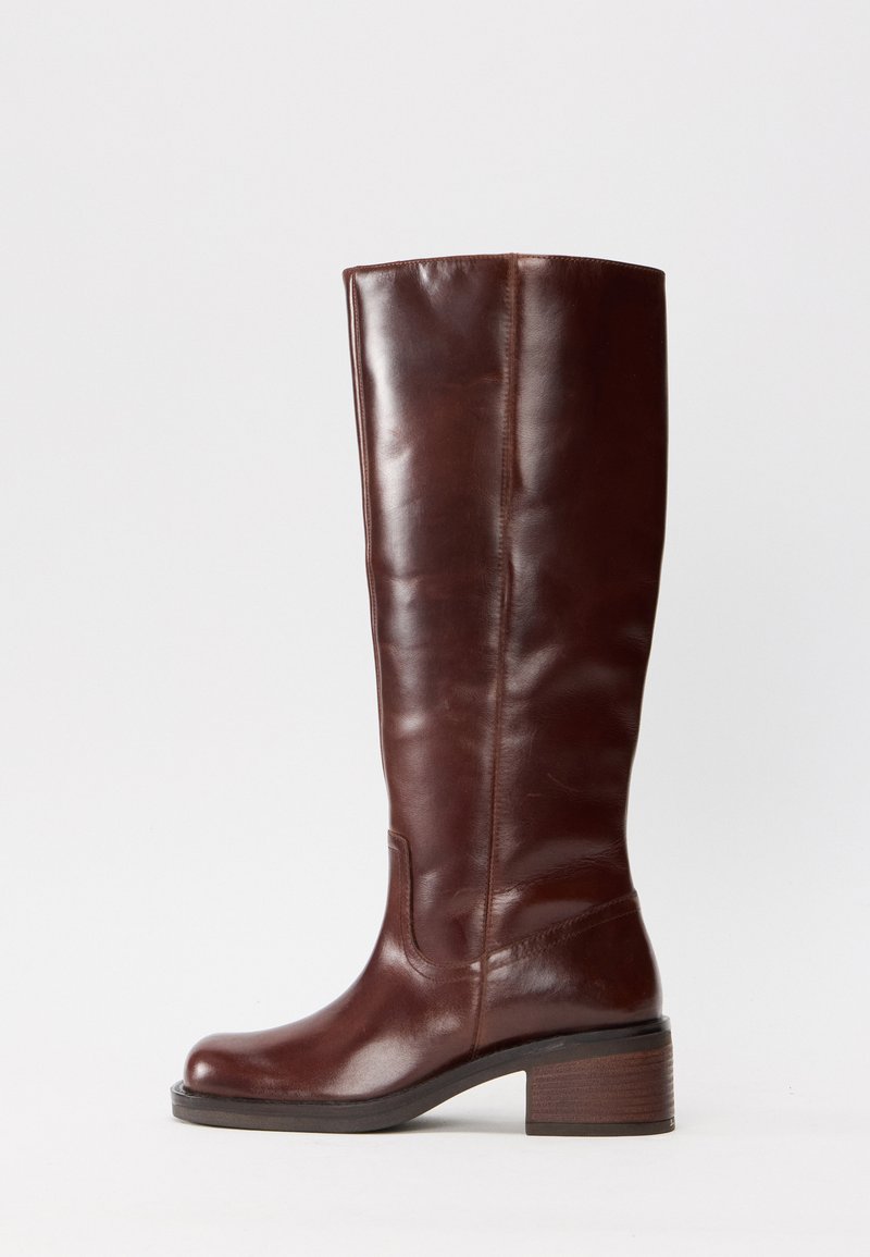 Brown leather knee-high boot with a rounded toe, smooth texture, and a block heel. Features a subtle seam detail along the shaft.