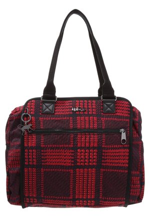 Sac à main rouge et noir à motifs avec deux poignées noires, poche avant zippée et un petit porte-clés singe attaché à la fermeture éclair.