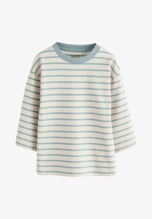 Lagani, kremasti dugih rukava s plavim horizontalnim prugama, okrugli izrez i ležeran kroj. Napravljen od mekanog pamučnog materijala.