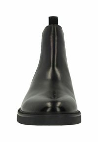 Black leather Chelsea boots with a sleek design, smooth texture, and elastic side panels. The sole is flat and rubberized, providing durability.