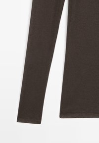 Long-sleeve brown cotton shirt with a smooth texture and rounded neckline. Features a straight-cut hem and fitted sleeves.