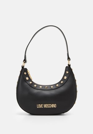 Black faux leather handbag with a curved silhouette, gold studs and floral accents, featuring a top zip closure and a shoulder strap.