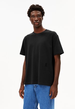 Black cotton t-shirt with a round neck and short sleeves. Features a subtle embroidered logo on the left chest area.