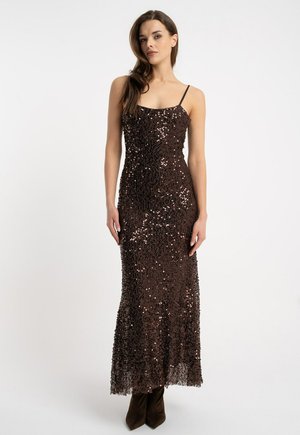 Brązowa wieczorowa sukienka z cekinami, z dopasowanym górnym krojem i cienkimi ramiączkami, o długiej do ziemi sylwetce i teksturowanej, lśniącej powierzchni.