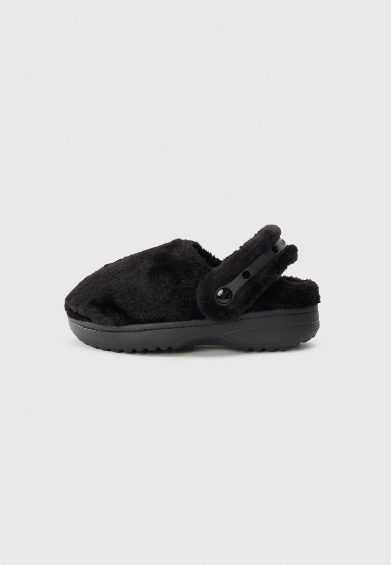 Black fur-lined clog with a soft texture, molded black rubber sole, and adjustable strap featuring two black buttons for support.