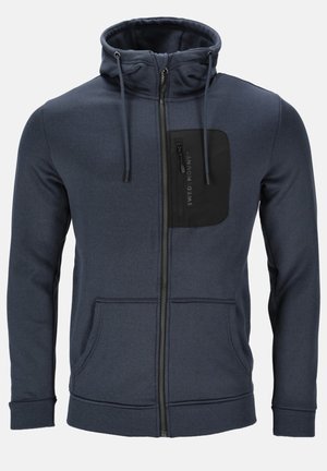 Marineblå zip-up hoodie lavet af blødt stof, med en sort brystlomme med lynlås, snore i hætten og sidelommer.