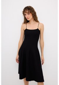 Abito nero con spalline sottili, corpino aderente e gonna ampia. Realizzato in tessuto texturizzato, lungo fino al ginocchio con dettagli di cuciture verticali.
