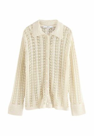 Cardigan en tricot dentelle crème avec un col, fermeture à boutons et manches longues. Présente un motif en maille ajourée et des poignets côtelés.