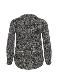 Blusa de manga larga con un patrón texturizado en blanco y negro. Presenta un escote redondo y puños elásticos, hecha de una tela suave.