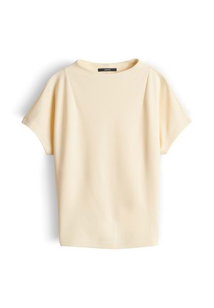 Cremefarbene, kurzärmelige Bluse mit rundem Ausschnitt und dezenten Falten an den Schultern, vor weißem Hintergrund präsentiert.