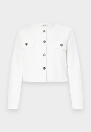 White cropped jacket made of textured fabric, featuring a round neckline, silver-button closure, and two chest pockets.