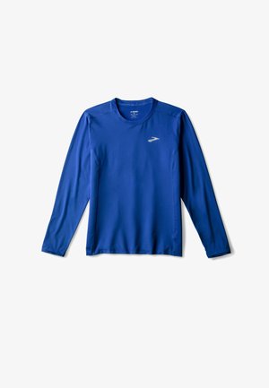Long-sleeve athletic shirt in bright blue with a round neck, smooth texture, and reflective silver logo on the front left.