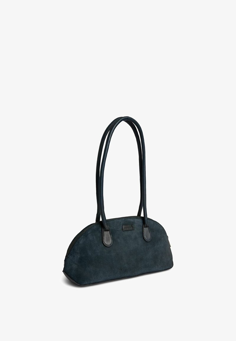 Petit sac à main bleu marine avec un sommet incurvé, de longues poignées doubles et une fermeture éclair sur le bord supérieur.